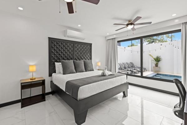 King bedroom with pool views at Villa Roberto