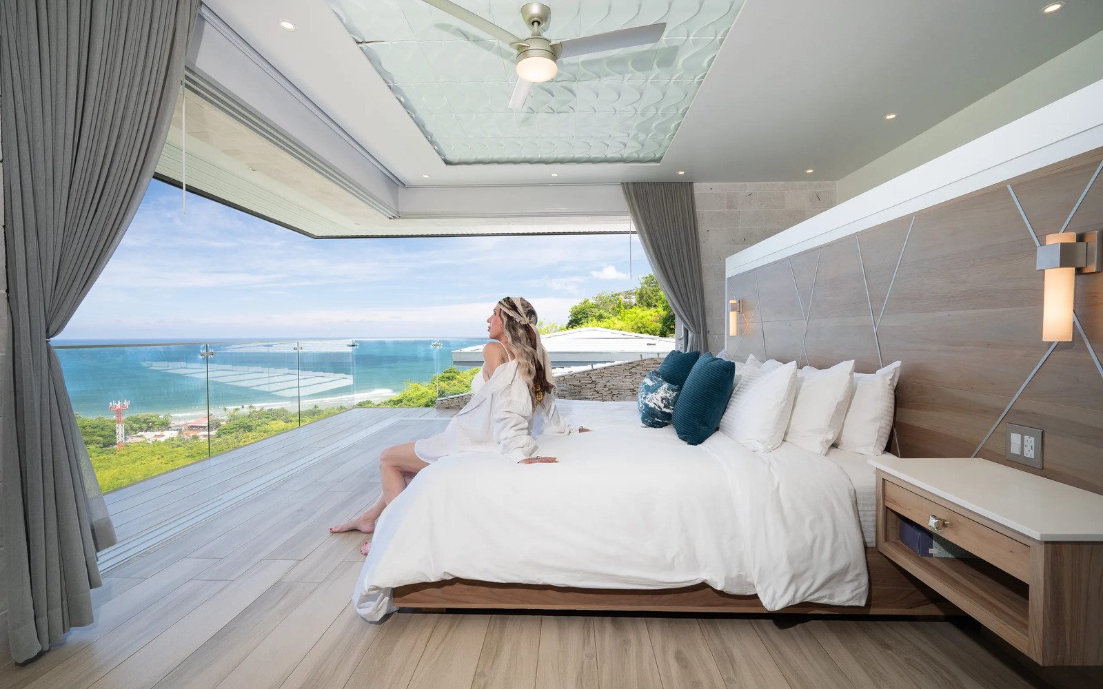 Primary bedroom opening to an ocean-view terrace at Villa Serenidad