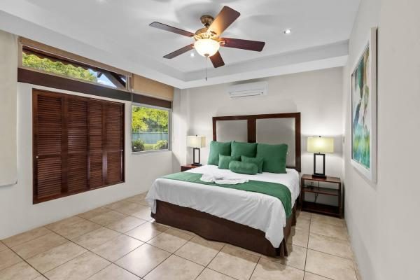 King bedroom with dark wood headboard at Rancho de Sueños