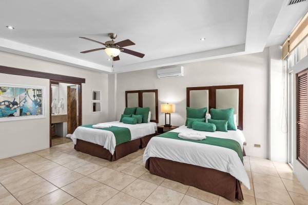 Guest bedroom with two queen beds at Rancho de Sueños